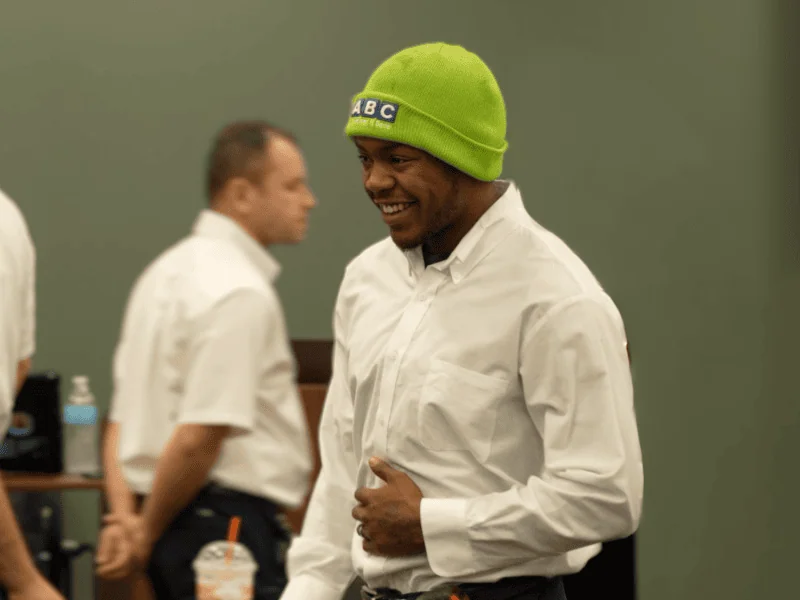 Man wearing green ABC hat