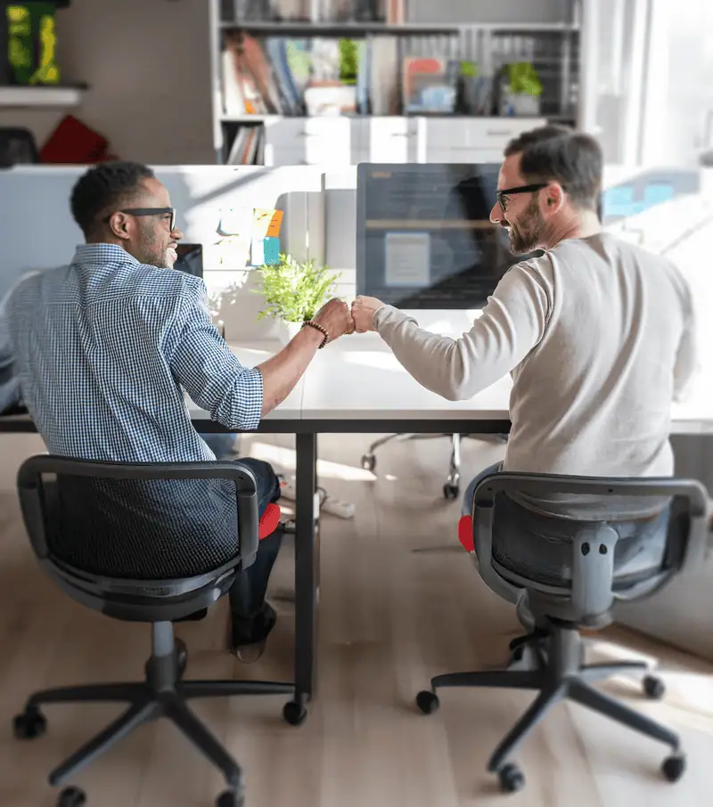 Two guys fist bumping